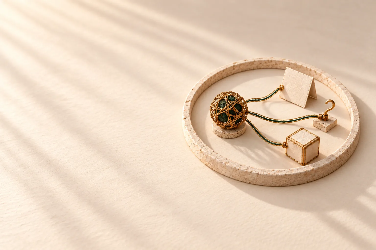 One woven sphere inside an unbroken stone ring, joined by three separate threads to three small pieces: a folded card, a wire hook and a paper box. Nothing crosses the ring.